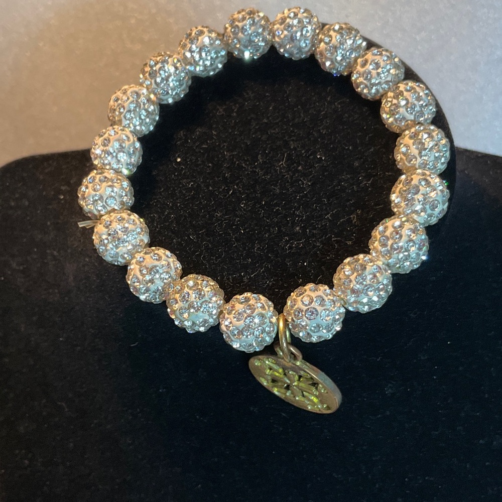 The white Emerson cuff features sparkling jeweled beads